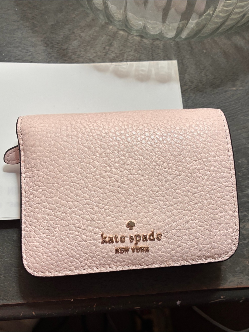kate spade pale pink pebbled leather compact wallet with gold logo